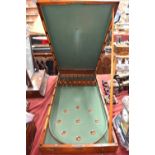 An antique mahogany cased folding bagatelle board, the interior baize lined and complete with balls,