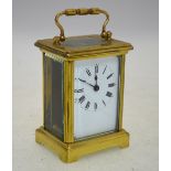 A French brass carriage clock with enamel dial,