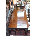 A large mahogany extending dining table, the top with rope moulded edge with wind action,