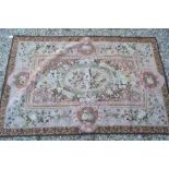 An Aubusson style needlepoint rug worked in rose, pale green and brown hues, 1.85 x 1.