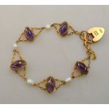 An Art Nouveau bracelet formed of five oval cabochon amethysts and four river pearls with chain