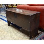 A 17th century oak six plank coffer with moulded edge hinged top over a conforming face plank,