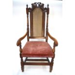 A 17th/18th century fruitwood framed cane back open armchair