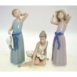 Three Lladro figures, comprising; a seated ballet dancer,