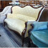 A Victorian mahogany framed serpentine sofa upholstered in fleur-de-lys design ochre fabric,