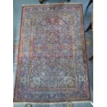 An antique silk Isphahan rug, floral design on wine ground,