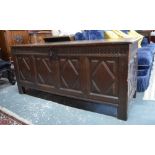 A 17th century oak coffer, the wide two plank top with moulded edge,