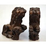 A pair of carved teak heraldic lions in the mediaeval manner,