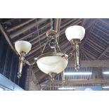An Art Deco style brass three branch electrolier with opaque glass shades