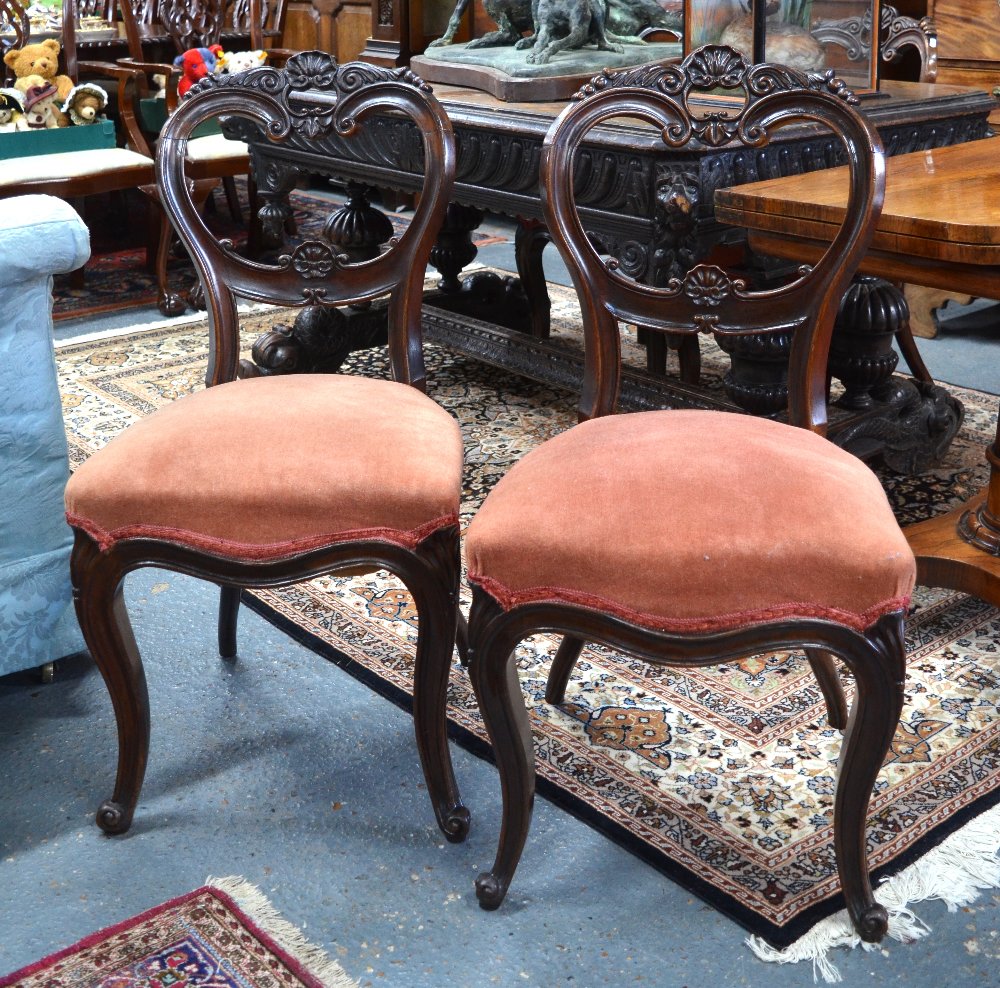 A set of four Victorian dark walnut side chairs,