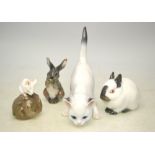 Three Royal Copenhagen models - Rabbit, no 4705; Rabbit, no 1019; Mouse on chestnut,