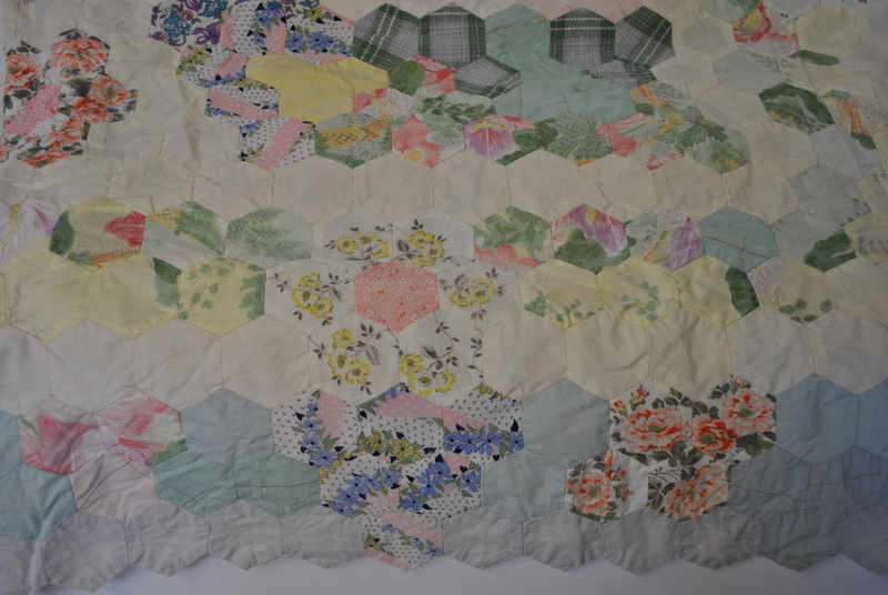 A 1970s hand-sewn patchwork quilt (un-backed) in hexagonal floral cotton, 210 x 205 cm,