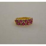 A ruby and diamond two row claw set eternity ring,