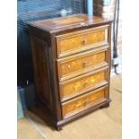 A 18th century Italian marquetry inlaid fruitwood chest of four long drawers with applied mouldings,