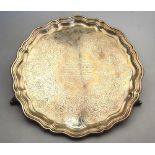 A Victorian letter salver with moulded rim and engraved decoration, on three scroll feet,