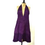 A 1970s yellow leather bodice, a purple suede halter neck dress, two leather skirts,