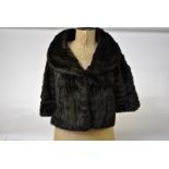 A dark brown French squirrel fur evening jacket with deep collar Condition Report