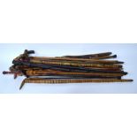 A bundle of sixteen various walking sticks and canes including African and Far Eastern examples