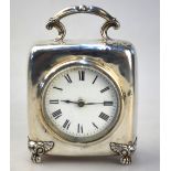 An Edwardian silver-cased boudoir clock with scrolling top-handle and winged paw feet,