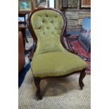 A Victorian mahogany framed buttoned spoon back salon chair with over-stuffed serpentine seat,