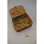 A small leather box containing a pearl and diamond stick pin,