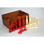 A 19th century ring-turned ivory chess-set with red dye, king 10.