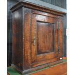 A 17th/18th century small panelled wall cupboard