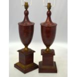 A pair of painted tin urn-shaped table lamps, in imitation of porphyry marble,