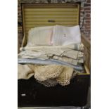 A small deep vintage trunk containing a quantity of damask and other sets of table napkins,