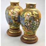 A pair of Satsuma-style vases; each one decorated with Rakan in high relief;
