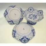 A pair of Meissen style deep dishes; each one with reticulated rims and floral designs;