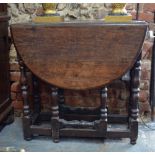 A 17th century oak small oval gateleg table with end drawer, on baluster turned supports (f/r),