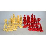 A 19th century ringed-turned ivory chess set with red dye, the king 11 cm high,