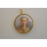 A circular pendant enclosing a watercolour portrait miniature of a young officer,