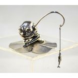 Sarah Jones: a miniature cast silver figure of Jeremy Fisher, seated, fishing, on a lily-pad,