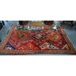 A red ground Shiraz rug, 2.20 x 1.