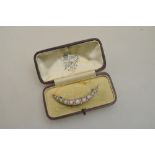 An opal and diamond open crescent style brooch yellow metal set on pierced gallery in fitted box