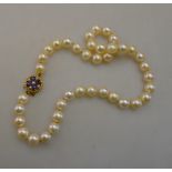 A single strand uniform cultured pearl choker necklace on an amethyst and pearl set 9ct yellow gold