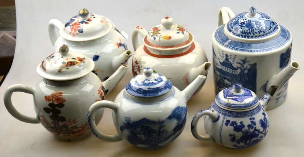 A small Chinese blue and white teapot wi