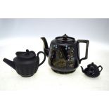 Three black teapots, comprising: an 1887