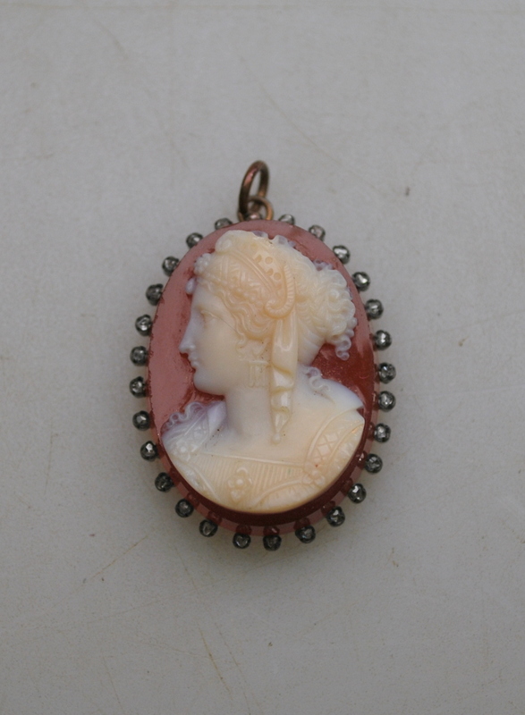 An antique oval agate cameo pendant of classical female with rose diamonds around,