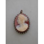 An antique oval agate cameo pendant of classical female with rose diamonds around,