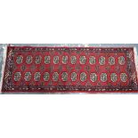 A Pakistan-Afghan design small runner, mid-red ground with two rows of stylised guls,