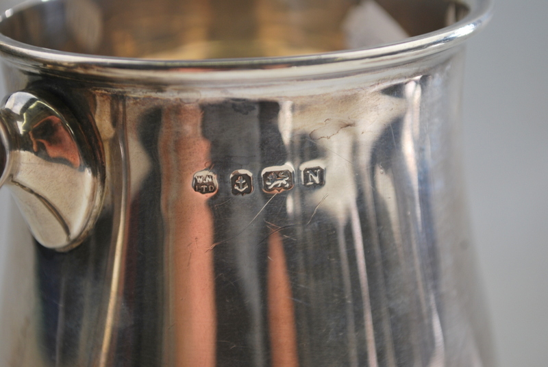 A silver baluster pint mug in the Georgian manner, with scroll handle and moulded foot-rim, - Image 3 of 3