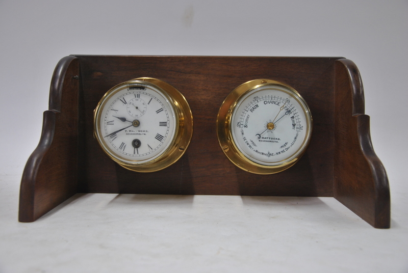 A brass marine barometer with matching clock, the 9 cm enamel dial inscribed for T. - Image 2 of 2