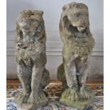 A heavily weathered pair of reconstituted stone seated lions,