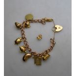 A 9ct yellow gold curb bracelet and padlock having ten various charms attached and one as yet