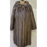 A 1950s dark smokey grey mink coat with cowl neck and single button fastening,