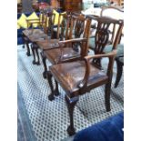 A set of six Georgian style mahogany dining chairs having pierced vertical splats over leather slip