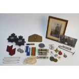 A quantity of police-related and other items, including helmet badges, whistles, photographs,